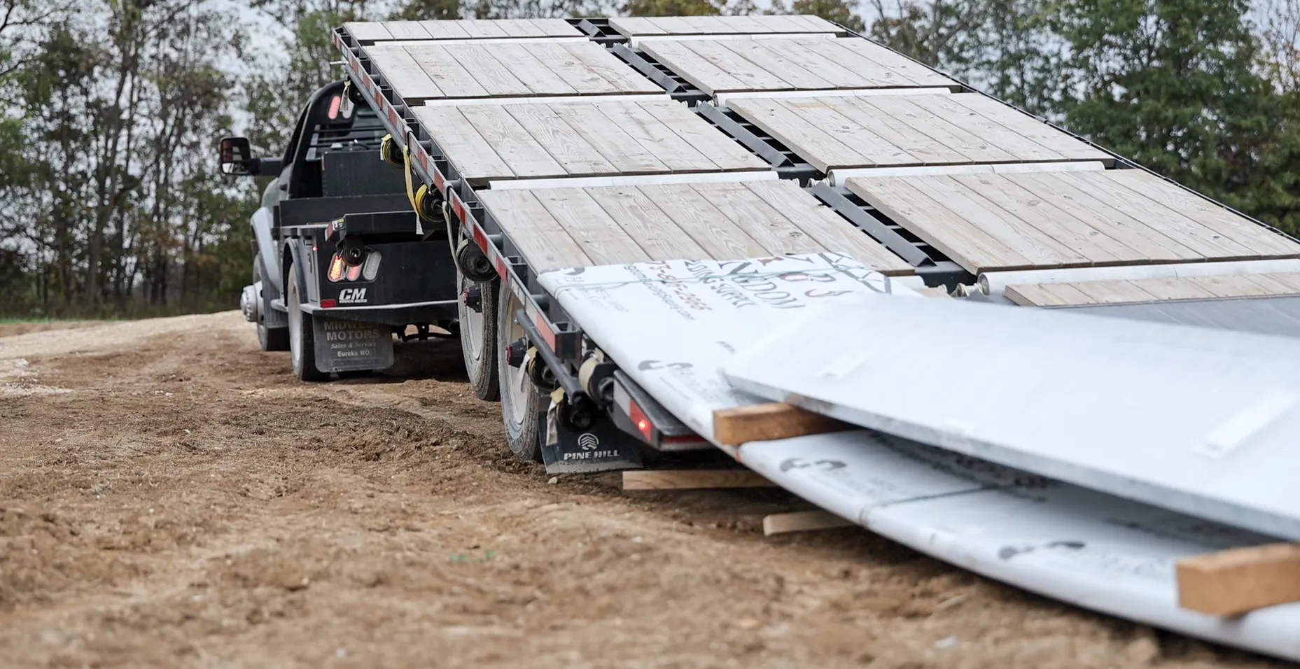 Delivery truck delivering metal to jobsite